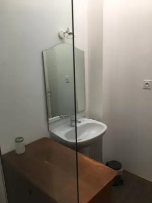 a bathroom with a sink and a mirror at La Cathare Appartement 2 chambres in Lézignan-Corbières