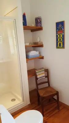 a chair in a room with a mirror and a shelf at Domaine de Las Planques in Vaudreuille