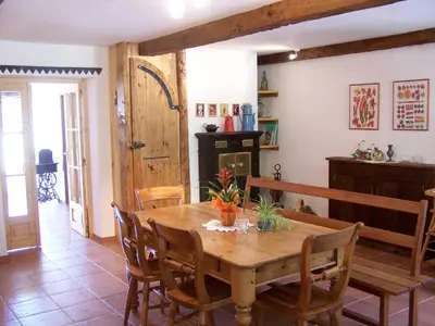 a dining room with a wooden table and chairs at Domaine de Las Planques in Vaudreuille
