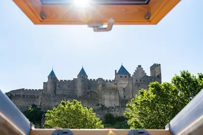 a view of a castle from a car window at Le Loft de La Tour Pinte in Carcassonne