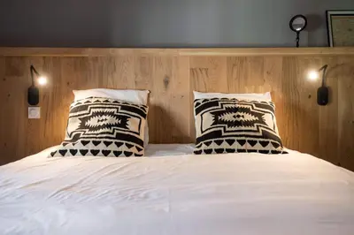 a bedroom with a bed with two pillows at Le Loft de La Tour Pinte in Carcassonne
