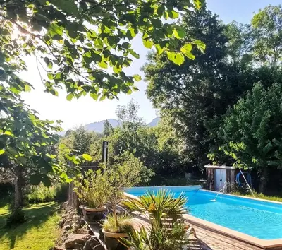 a swimming pool in the yard of a house at Infocus-Du-Sud in Soula
