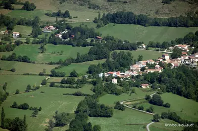 an aerial view of a small village in a green field at Infocus-Du-Sud in Soula
