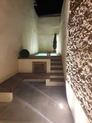 a staircase in a room with a stone wall at Au pied de la Cité Médiévale, piscine, vue extraordinaire, gîte La Trivala à Carcassonne in Carcassonne