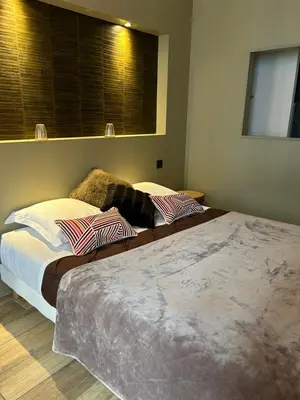 a bedroom with two beds and a window at Au pied de la Cité Médiévale, piscine, vue extraordinaire, gîte La Trivala à Carcassonne in Carcassonne