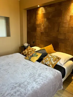 a bedroom with two beds with pillows on it at Au pied de la Cité Médiévale, piscine, vue extraordinaire, gîte La Trivala à Carcassonne in Carcassonne