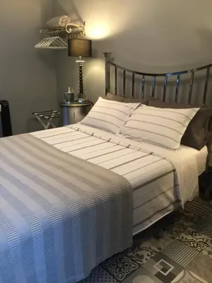 a bedroom with a large bed with a striped comforter at Chez Montiz in Montazels