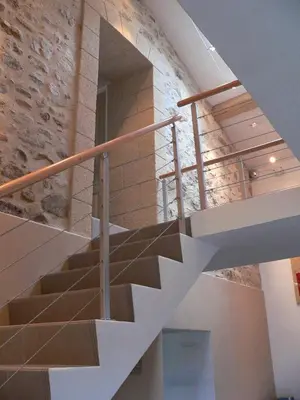 a staircase in a building with a stone wall at La Terrasse in Sorèze