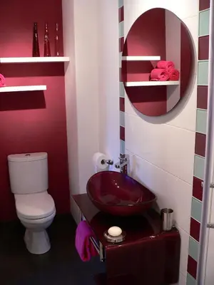 a bathroom with a red sink and a toilet at La Terrasse in Sorèze