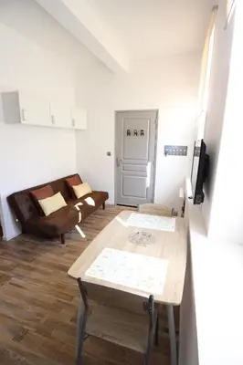 a living room with a couch and a table at Studio proche de la mer in Portel-des-Corbières