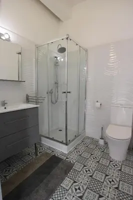 a bathroom with a shower and a toilet and a sink at Studio proche de la mer in Portel-des-Corbières