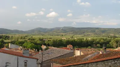 a view of a village with mountains in the background at Le Sommet in Paziols