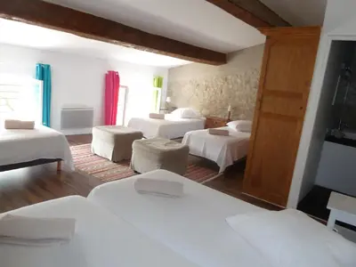 a bedroom with three beds and a room with at La maison d' Elizabeth in Lagrasse