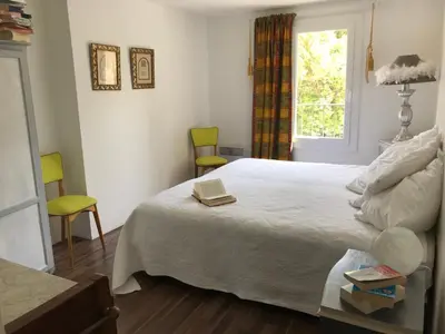 a bedroom with a bed with a book on it at La maison d' Elizabeth in Lagrasse