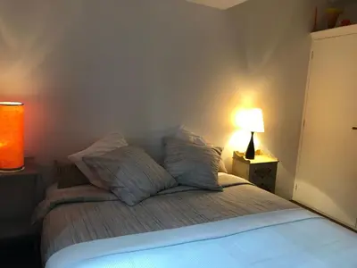 a bedroom with a bed with two pillows and a lamp at La maison d' Elizabeth in Lagrasse