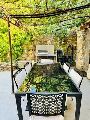 a table and chairs on a patio at Camin del Bosc in Roquefort-des-Corbières