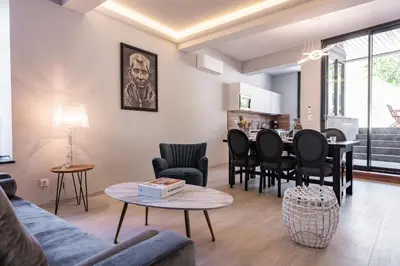 a living room with a couch and a table at La terrasse de La Tour Pinte. in Carcassonne