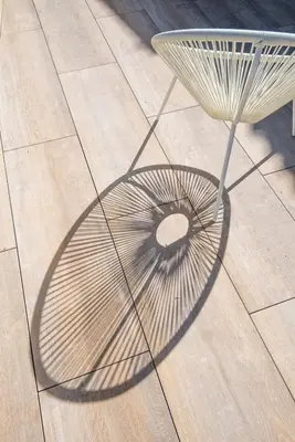 a table and its shadow on the floor at La terrasse de La Tour Pinte. in Carcassonne
