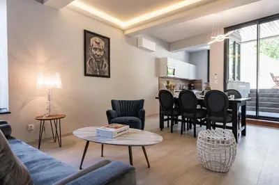 a living room with a couch and a table at La terrasse de La Tour Pinte. in Carcassonne