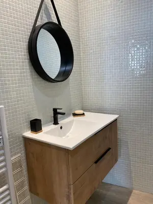 a bathroom with a sink and a mirror on the wall at Trésors de la Cathédrale, Maison de Ville sur 4 niveaux in Narbonne