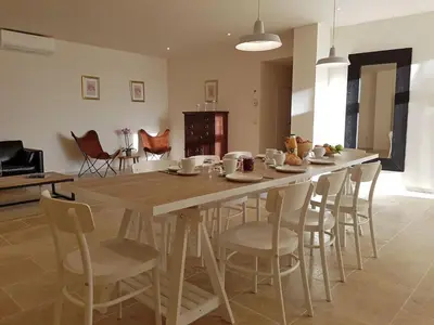 a table and chairs in a living room at Tranquil Stay in Villesèque in Villesèque-des-Corbières