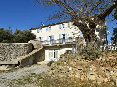 a white house with a tree in front of it at Tranquil Stay in Villesèque in Villesèque-des-Corbières