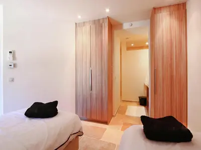 a bedroom with a bed and a wooden closet at Cozy Escape in Villesèque in Villesèque-des-Corbières