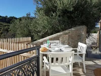 a white table and chairs on a balcony at Cozy Escape in Villesèque in Villesèque-des-Corbières