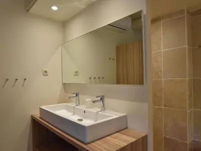 a bathroom with a white sink and a mirror at Blissful Stay in Mandourelle in Villesèque-des-Corbières