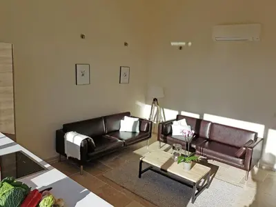 a living room with two leather couches and a coffee table at Serene Family Escape in Villesèque-des-Corbières