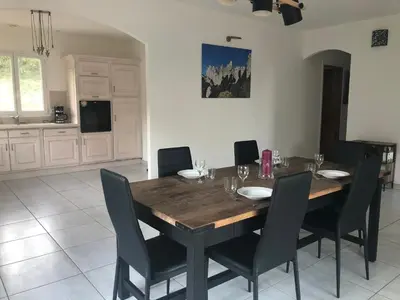 a dining room with a wooden table and chairs at Gîte San Jordi in Duilhac