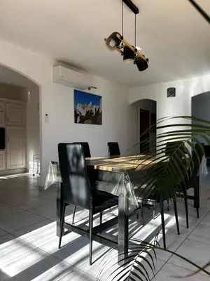 a dining room with a glass table and chairs at Gîte San Jordi in Duilhac
