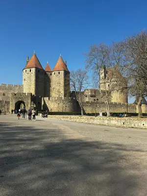 a large castle with people walking in front of it at Gîte San Jordi in Duilhac