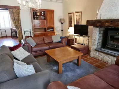 a living room with couches and a fireplace at Domaine de Pouroutounat in Mirepoix