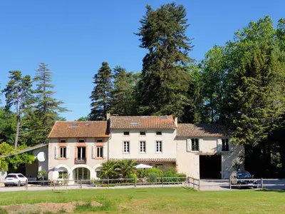 a large white house with a tree at Domaine de Pouroutounat in Mirepoix