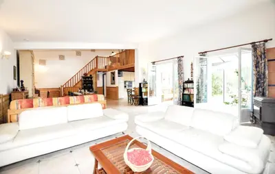 a living room with two white couches and a table at Villa tranquille à Montséret avec piscine privée in Montséret