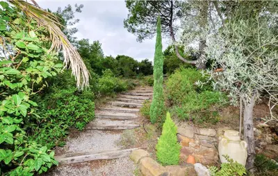 a set of stone stairs in a garden at Villa tranquille à Montséret avec piscine privée in Montséret