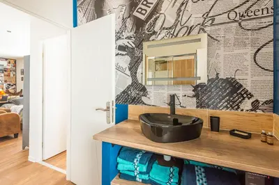 a bathroom with a sink and a mirror at L'urbain Narbonnais in Narbonne