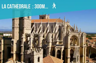 a large building with a clock tower in front of it at L'urbain Narbonnais in Narbonne