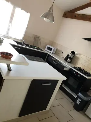 a kitchen with a white counter top and a stove at le verso in Narbonne