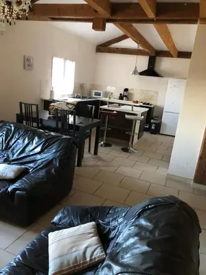 a living room with a couch and a kitchen at le verso in Narbonne
