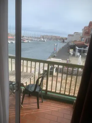 a balcony with a bench and a view of the water at Location Nuit Studio Port Gruissan in Gruissan