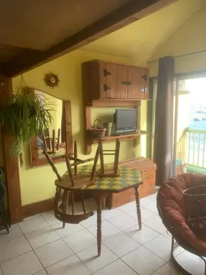 a living room with a table and a chair at Location Nuit Studio Port Gruissan in Gruissan
