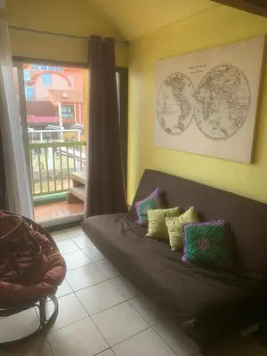 a room with a bed with pillows and a window at Location Nuit Studio Port Gruissan in Gruissan