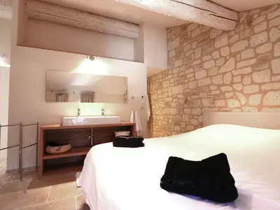 a bedroom with a white bed and a sink at Classy Apartment in Villesèque-des-Corbières with Swimming Pool in Villesèque-des-Corbières