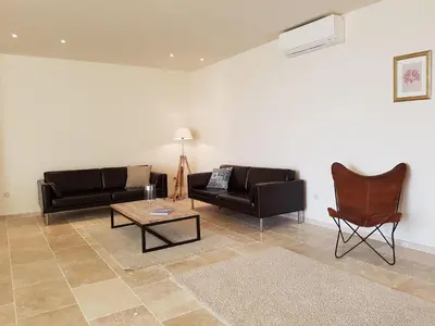 a living room with two couches and a coffee table at Classy Apartment in Villesèque-des-Corbières with Swimming Pool in Villesèque-des-Corbières