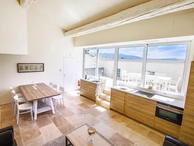 a kitchen and dining room with a table and a large window at Classy Apartment in Villesèque-des-Corbières with Swimming Pool in Villesèque-des-Corbières