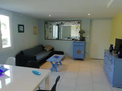 a living room with a couch and a table at Gîte le pastel in Puéchoursi