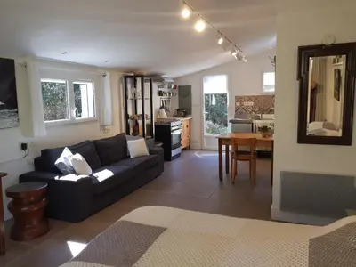 a living room with a couch and a table at Beautiful studio surrounded by nature in Lanet