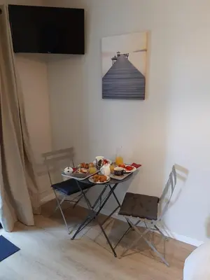 a table with plates of food on it in a room at La Villa Claudia Jardin et Spa in Pennautier